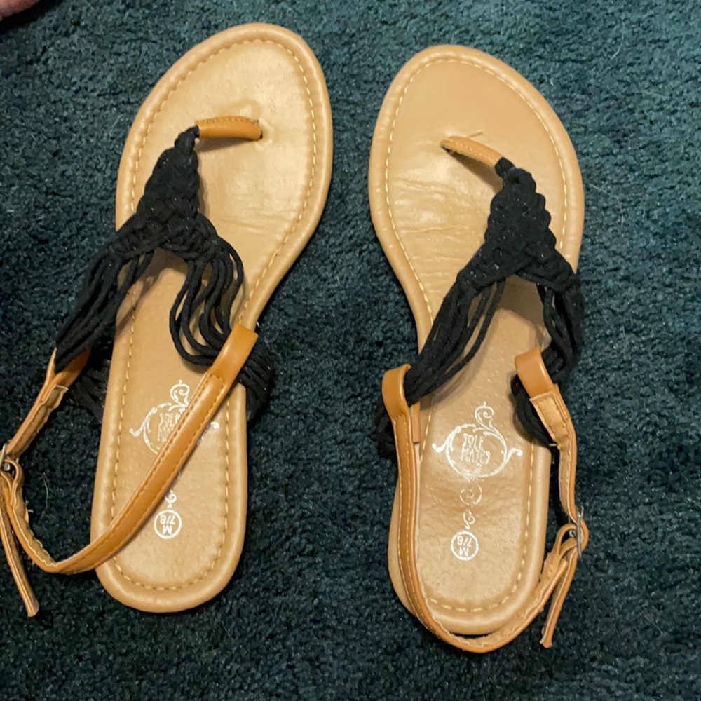 A pair of new black and brown sandals never worn